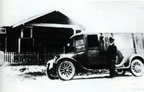 Paul U. Lee is shown with an early hearse in front of his funeral home.